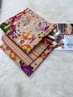 Stack of fabric samples with intricate patterns on a white surface