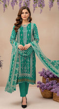 Green embroidered traditional outfit with dupatta, necklace, and jewelry on a beige background.
