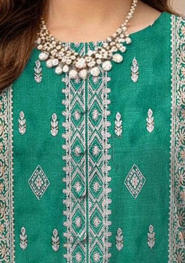 Green embroidered traditional outfit with dupatta, necklace, and jewelry on a beige background.