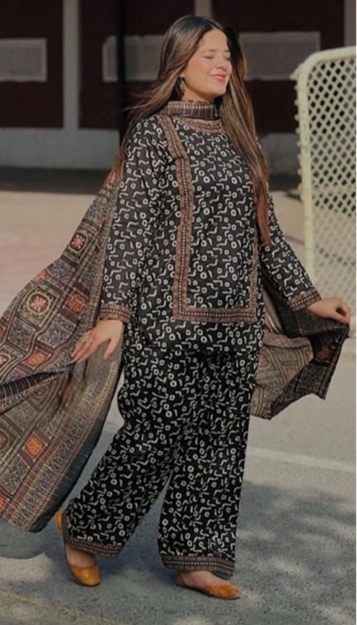 Woman wearing a printed karandi outfit with a dupatta, labeled 'Sapphire Digital Printed Karandi'.