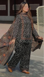 Woman wearing a printed karandi outfit with a dupatta, labeled 'Sapphire Digital Printed Karandi'.